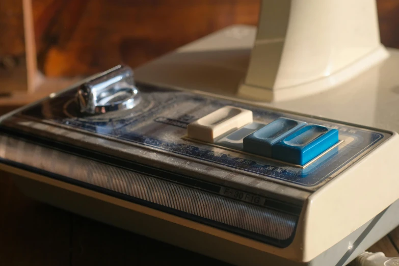 a close up of a machine on a table, by Elsa Bleda, flickr, cream and blue color scheme, nes, seventies era, blender