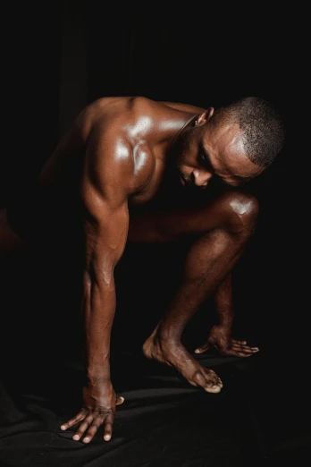 a man doing a handstand pose against a black background, an album cover, inspired by Terrell James, hyperrealism, detailed skin, they are crouching, mid-shot of a hunky, contemplative