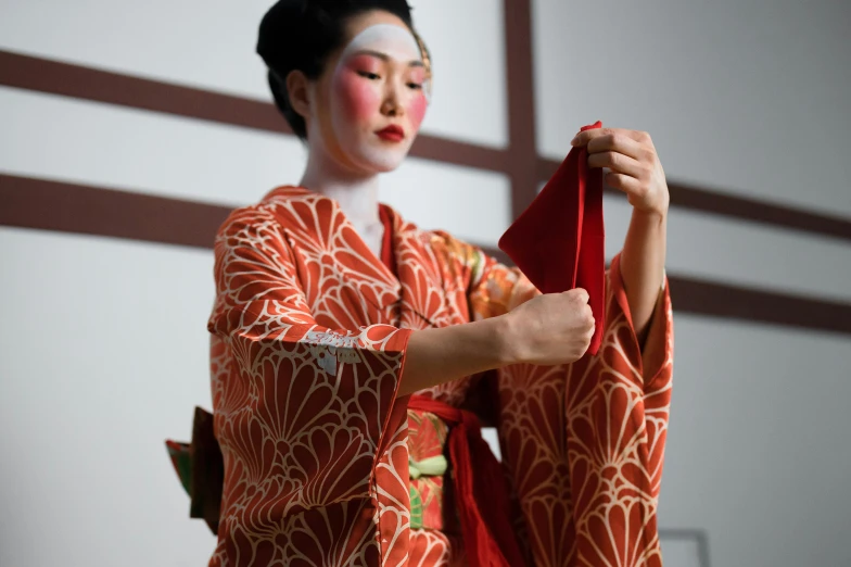 a close up of a person in a kimono, transforming, square, getty images, performing