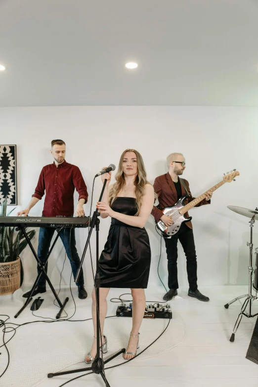 a group of people that are standing in a room, an album cover, pexels, band playing, in a white room, vine, jovana rikalo