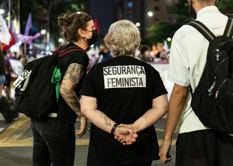 a group of people that are standing in the street, a tattoo, by Fernando Gerassi, feminist art, fascist police, contain, square, gettyimages