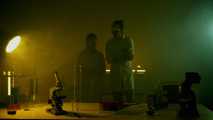a couple of men standing next to each other in a dark room, by Mike Winkelmann, science lab, dynamic movie still, smoky laboratory, movie action still frame