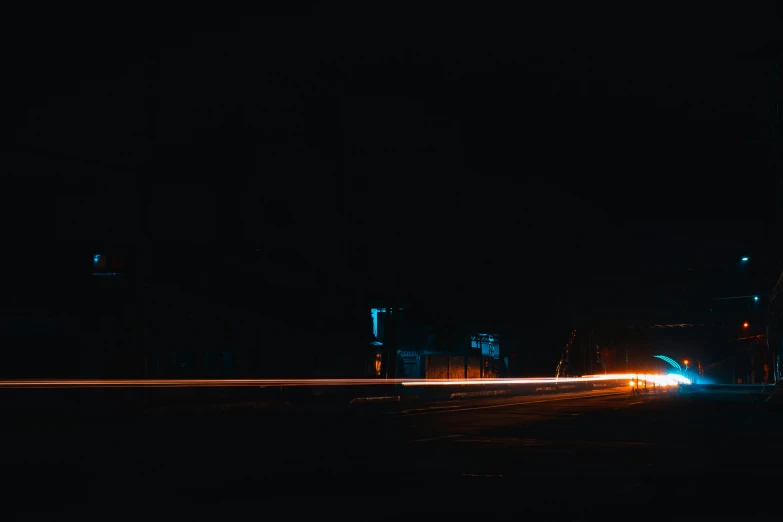 a car driving down a street at night, a picture, unsplash contest winner, visual art, lines of lights, lit from the side, orange and cyan lighting, in front of a black background