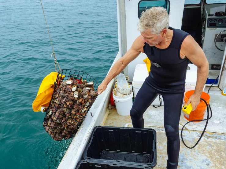 a man that is standing on a boat in the water, shells and barnacles, crabcore, carrying a tray, professional photo