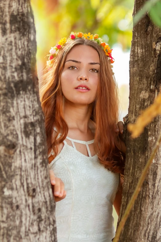 a woman standing next to a tree with a flower crown on her head, a portrait, by Alexander Fedosav, pixabay contest winner, gorgeous female samara weaving, she has long orange brown hair, color photograph portrait 4k, anna nikonova aka newmilky