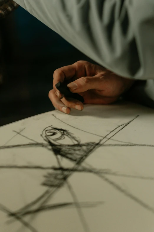 a close up of a person drawing on a piece of paper, by Adam Szentpétery, visual art, symmetrical artwork. cinematic, art from harry potter, pixar and da vinci, promo image