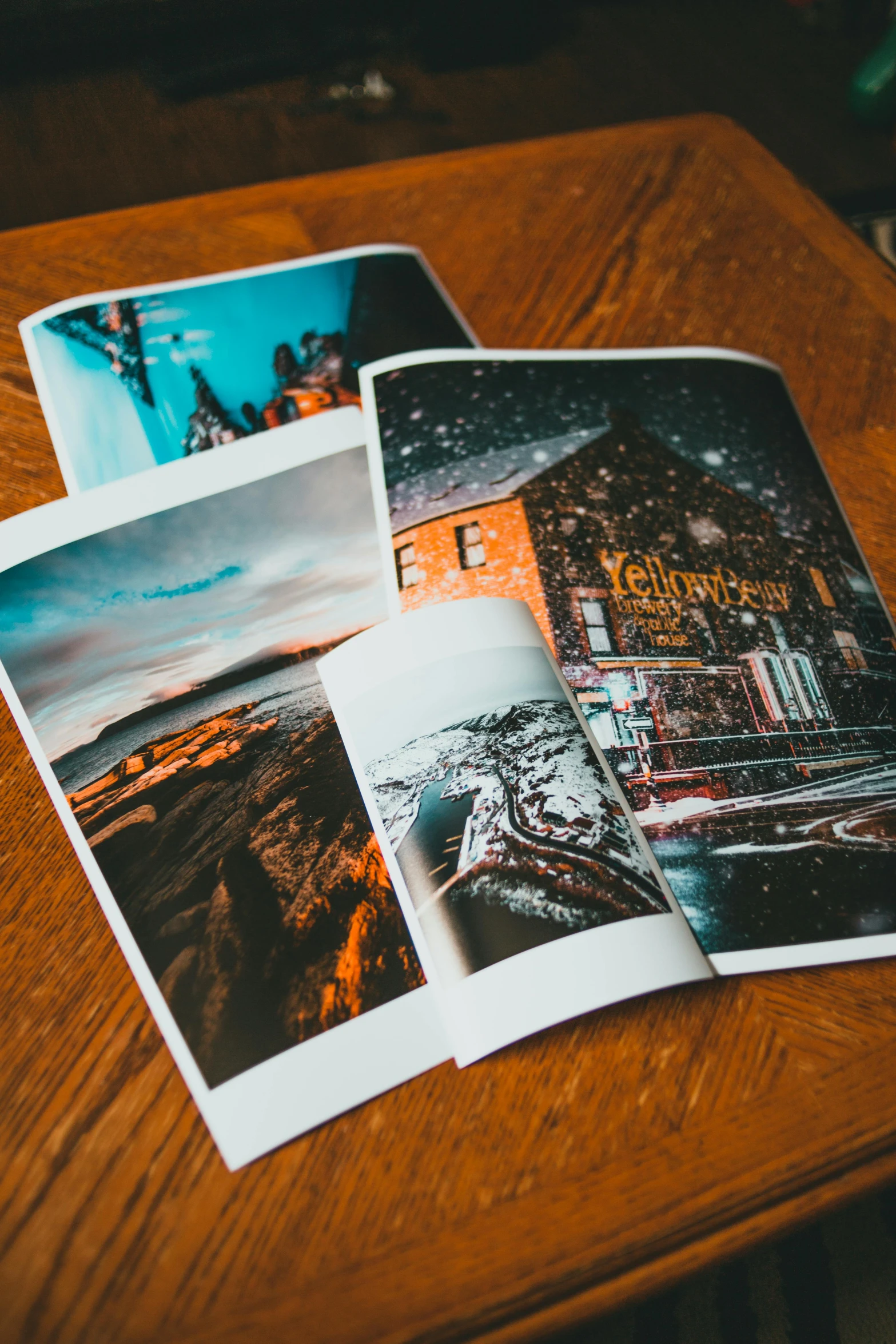 a pile of photos sitting on top of a wooden table, taverns nighttime lifestyle, 4 color print, thumbnail, winter