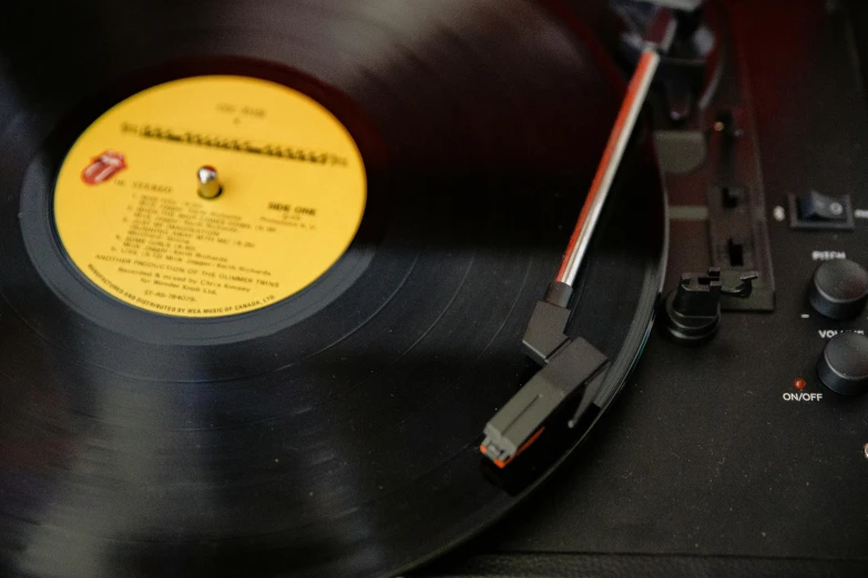 a record sitting on top of a turntable, an album cover, pexels, youtube thumbnail, yellow, shot on sony a 7 iii, black