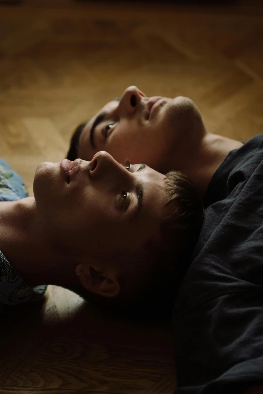 a man and a woman laying on the floor, trending on pexels, bauhaus, lgbt, perfectly lit. movie still, two young men, ukrainian