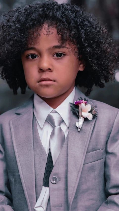 a young boy wearing a suit and tie, an album cover, inspired by Louis Le Nain, pexels contest winner, grey skin, mixed race, flower child, platinum attire