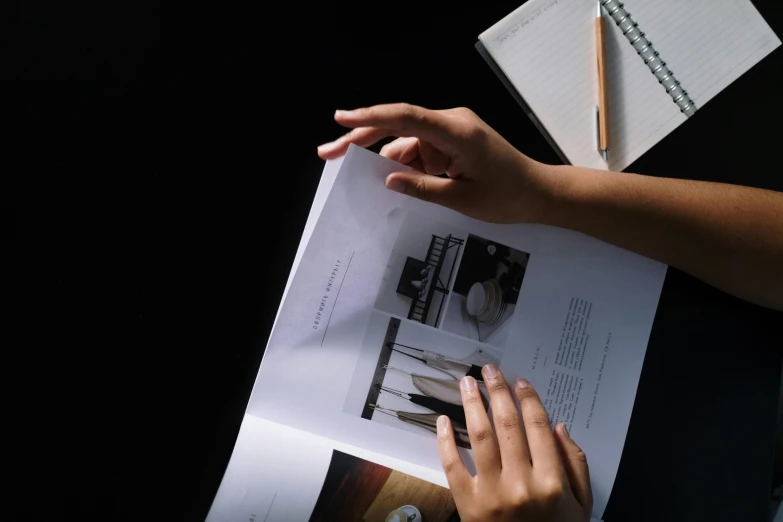 a person sitting at a table reading a book, pexels contest winner, visual art, on black background, brochure, on white paper, ignant