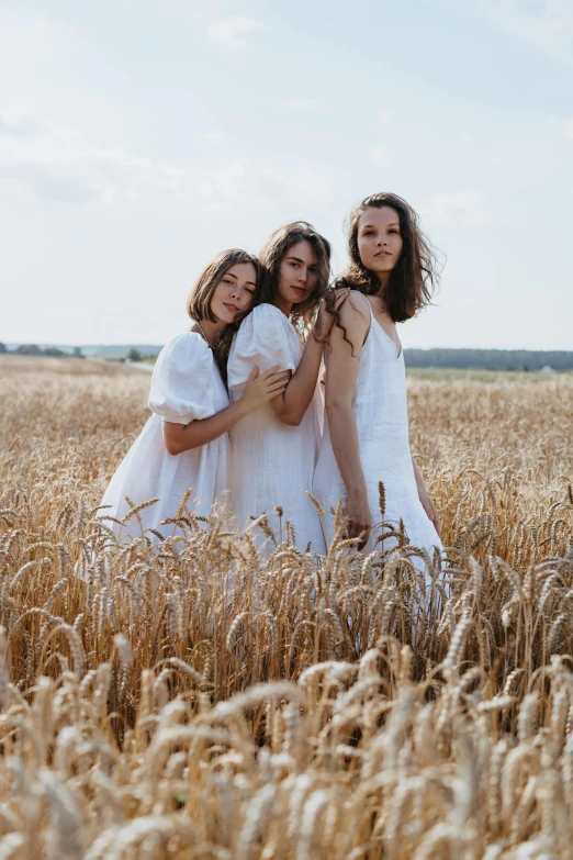 three women in white dresses standing in a wheat field, by Attila Meszlenyi, trending on pexels, pose model, concert, promotional image, brunettes