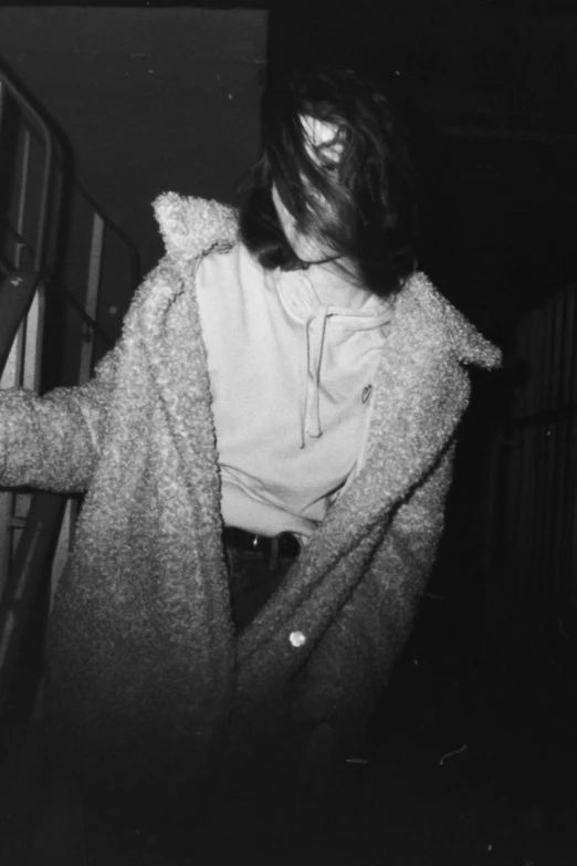 a black and white photo of a woman in a coat, inspired by Elsa Bleda, happening, tumblr aesthetic, petra collins, late night, white jacket