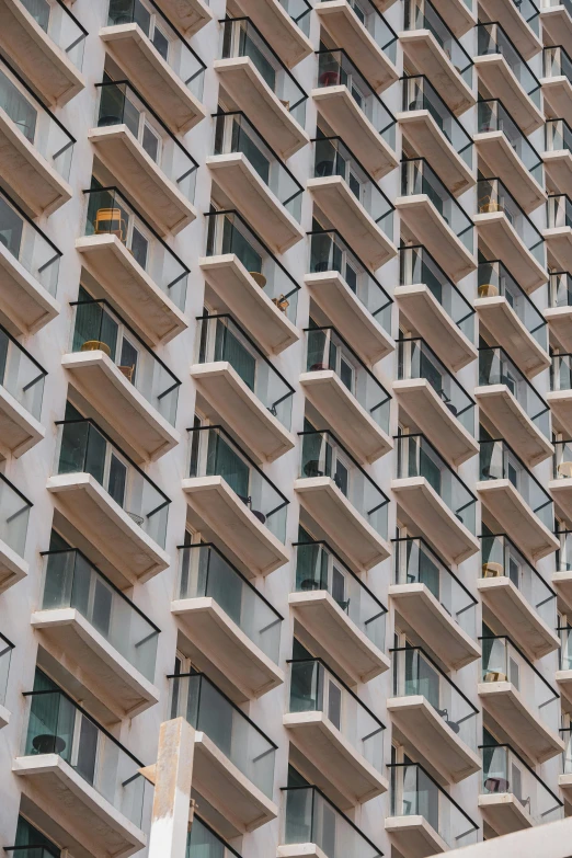 a traffic light hanging from the side of a tall building, inspired by Andreas Gursky, unsplash, brutalism, balcony door, staggered terraces, shoreline, hotel room