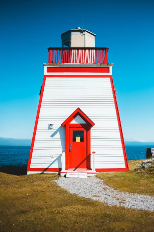 a white and red lighthouse with a red door, slide show, canada, square, multicoloured