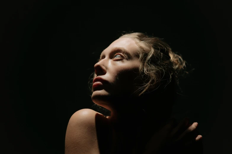 a woman standing in the dark with her eyes closed, inspired by Elsa Bleda, unsplash, hyperrealism, sydney sweeney, show from below, medium format. soft light, sunbathed skin