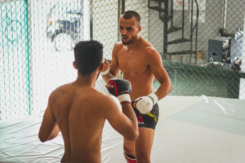 a couple of men standing next to each other, inspired by Volkan Baga, pexels contest winner, les nabis, preparing to fight, square, practice, thiago alcantara