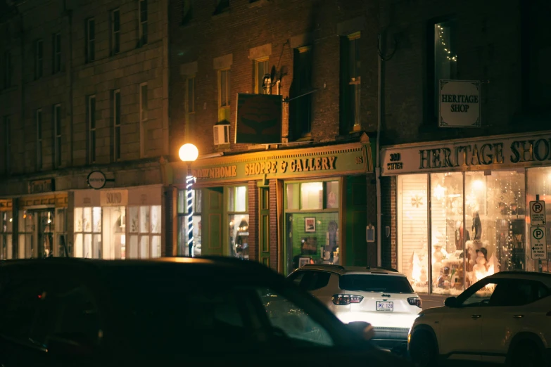 a couple of cars that are parked in front of a building, by Thomas Fogarty, pexels contest winner, renaissance, dimly lit dive bar, liminal bookshop, merchant street, seen from far away