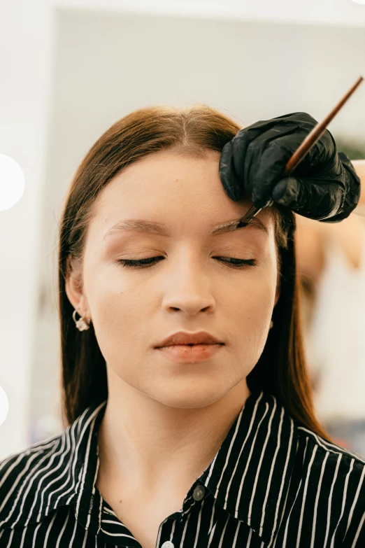 a woman getting her hair done at a salon, an airbrush painting, by Julia Pishtar, trending on pexels, mannerism, eyebrow scar, front portrait, line sleek, wearing eye shadow