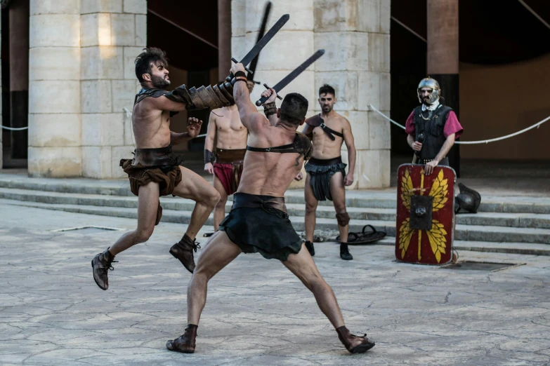 a group of men that are standing in the street, inspired by Exekias, pexels contest winner, renaissance, action scene from the film, in a coliseum, spear, mid - action