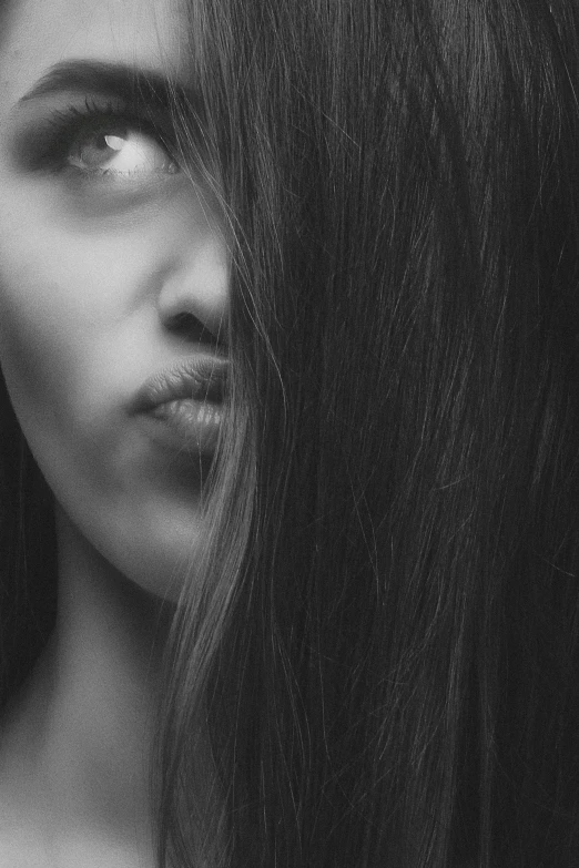a black and white photo of a woman with long hair, pexels contest winner, realism, closed lips, hiding, long thin black hair, half woman