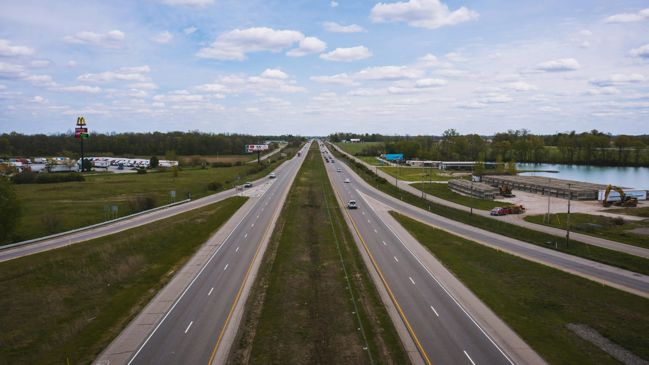 an aerial view of a highway near a body of water, by Daniel Seghers, unsplash, photorealism, michigan, 2000s photo, fan favorite, the scary empty liminal spaces