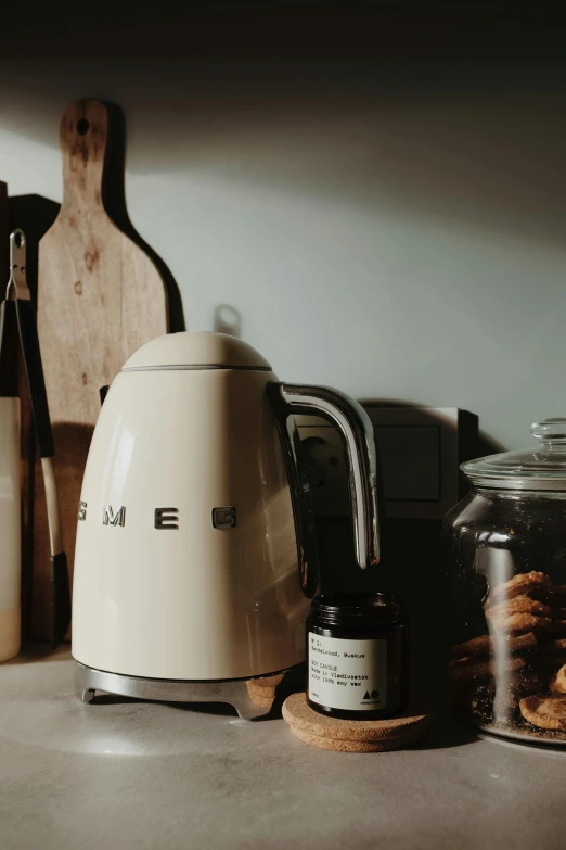 a white tea kettle sitting on top of a counter, a still life, by Everett Warner, pexels contest winner, toaster, panoramic shot, dwell, late summer evening