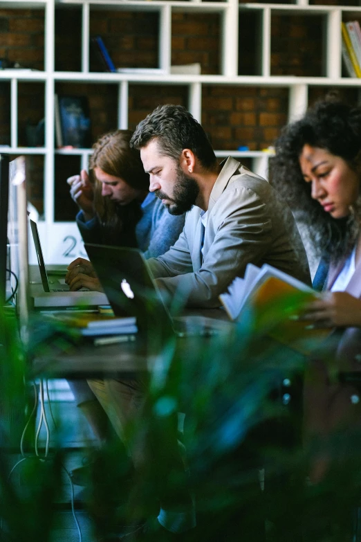 a group of people sitting at a table with laptops, by Adam Marczyński, pexels, renaissance, profile image, sleepy, excel running on the computer, caucasian