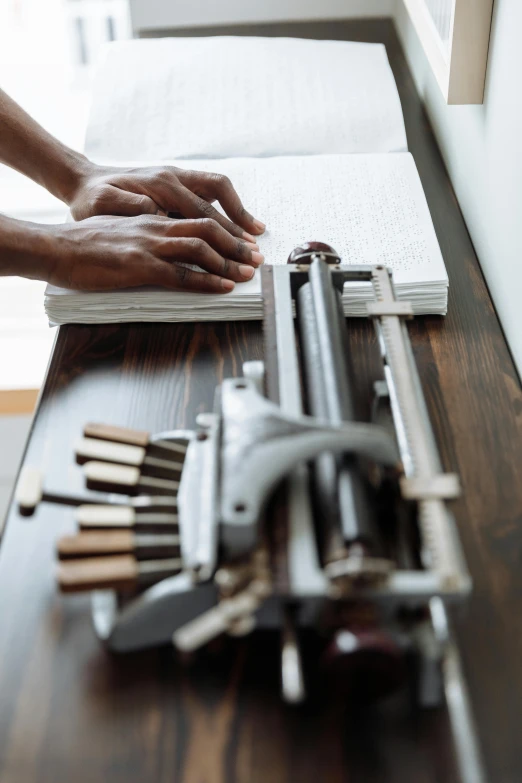 a person using a typewriter on a wooden table, professional gunsmithing, profile image, thumbnail, crafts