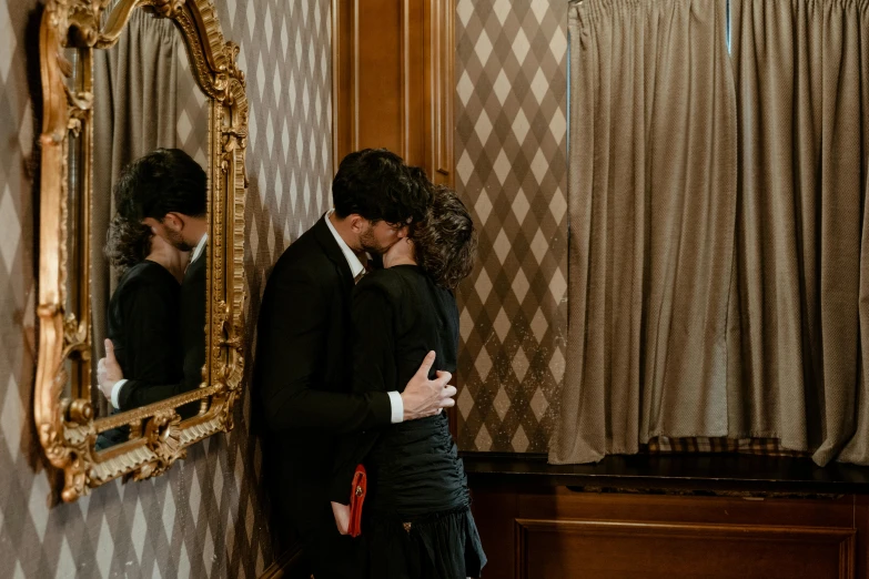 a man and a woman kissing in front of a mirror, pexels contest winner, romanticism, elegantly dressed, background image, in a hotel hallway, maurizio cattelan