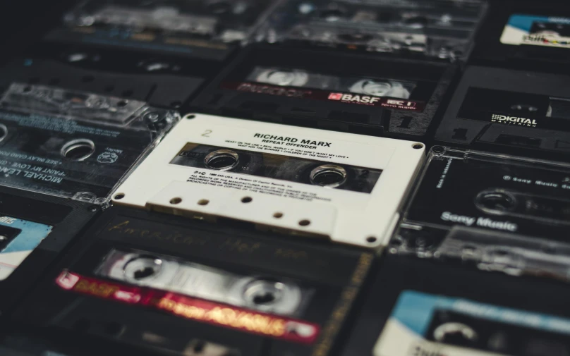 a pile of cassettes sitting on top of each other, inspired by John E. Berninger, trending on pexels, light and dark, turntablist, 40mm tape, music notes