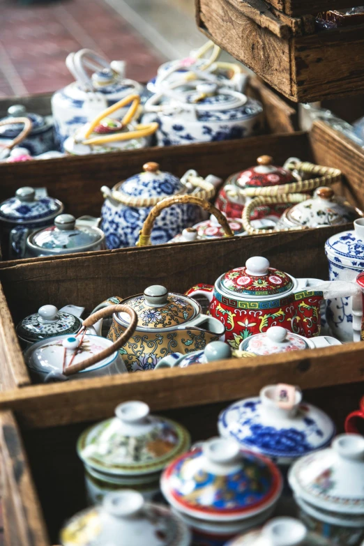 a wooden box filled with lots of different types of teapots, trending on unsplash, cloisonnism, square, market setting, finely painted, in style of thawan duchanee