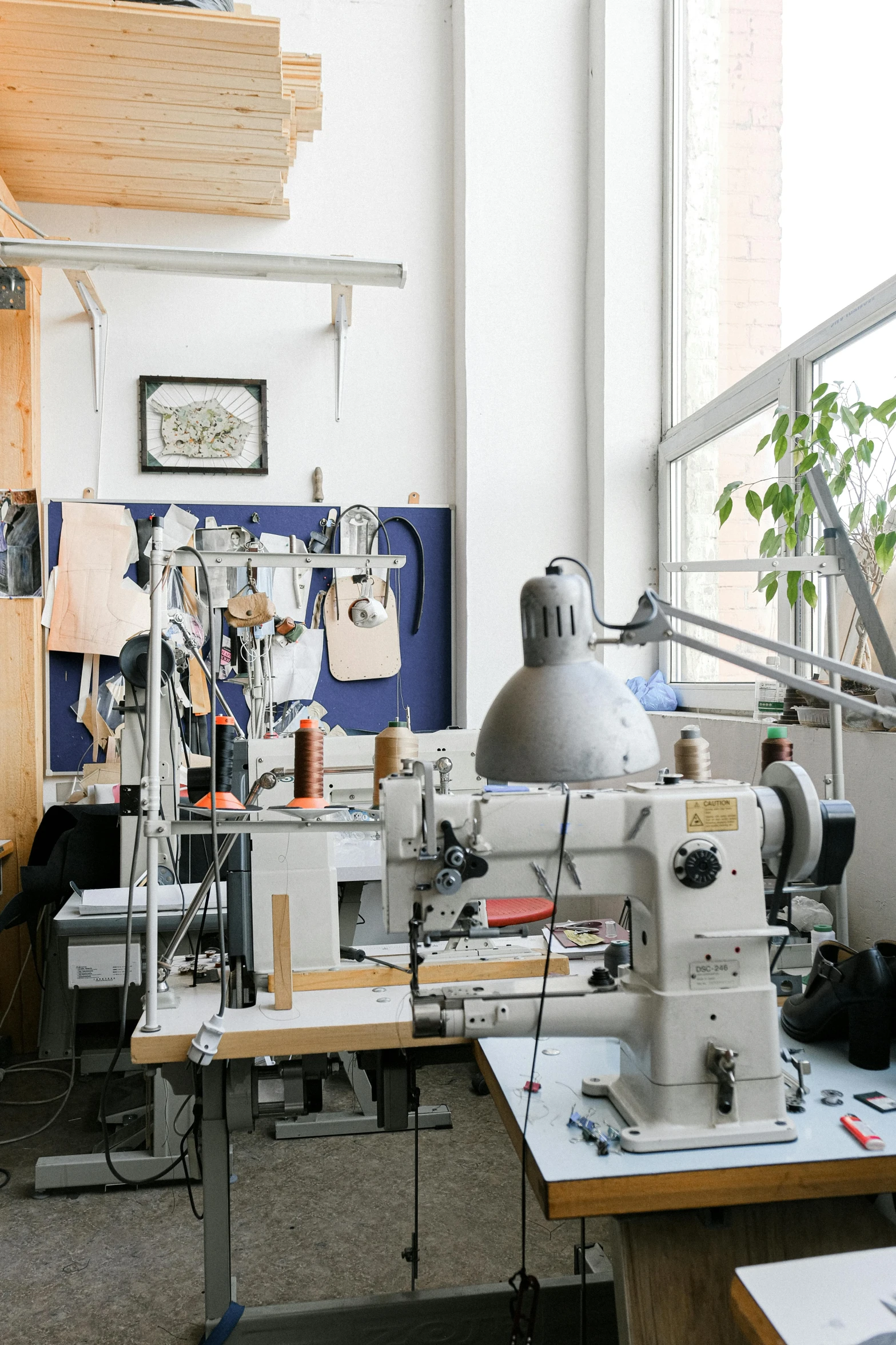 a sewing machine sitting on top of a wooden table, a silk screen, arbeitsrat für kunst, panorama, thumbnail, backrooms office space, tailored clothing