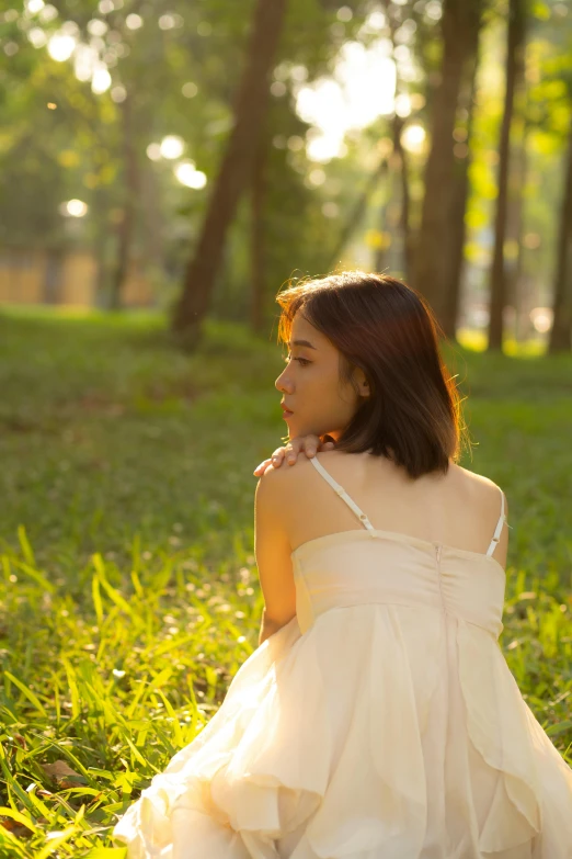 a woman in a white dress sitting in the grass, inspired by Kim Du-ryang, unsplash, romanticism, back lit, wearing a camisole, profile pic, anime thai girl