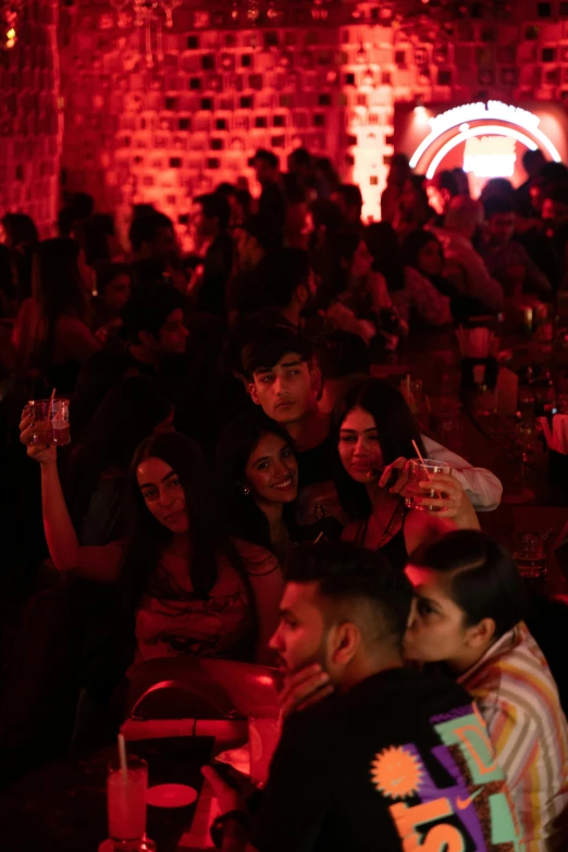 a man standing in front of a crowd of people, chillin at the club together, red magic surrounds her, hasan piker, photograph taken in 2 0 2 0