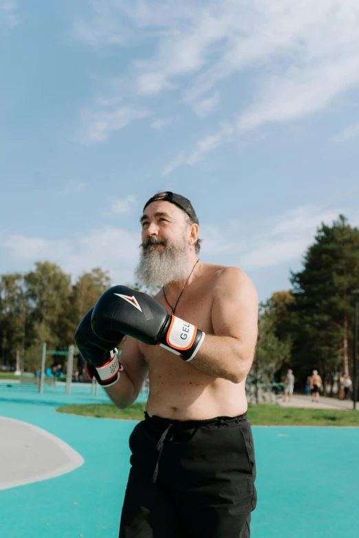 a man with a beard wearing boxing gloves, by Ilya Ostroukhov, happening, at a park, tjalf sparnaay 8 k, 🚿🗝📝, of a shirtless