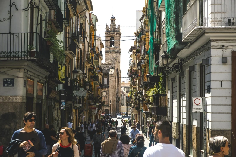 a group of people walking down a street next to tall buildings, inspired by Modest Urgell, pexels contest winner, renaissance, arrendajo in avila pinewood, square, thumbnail, an olive skinned