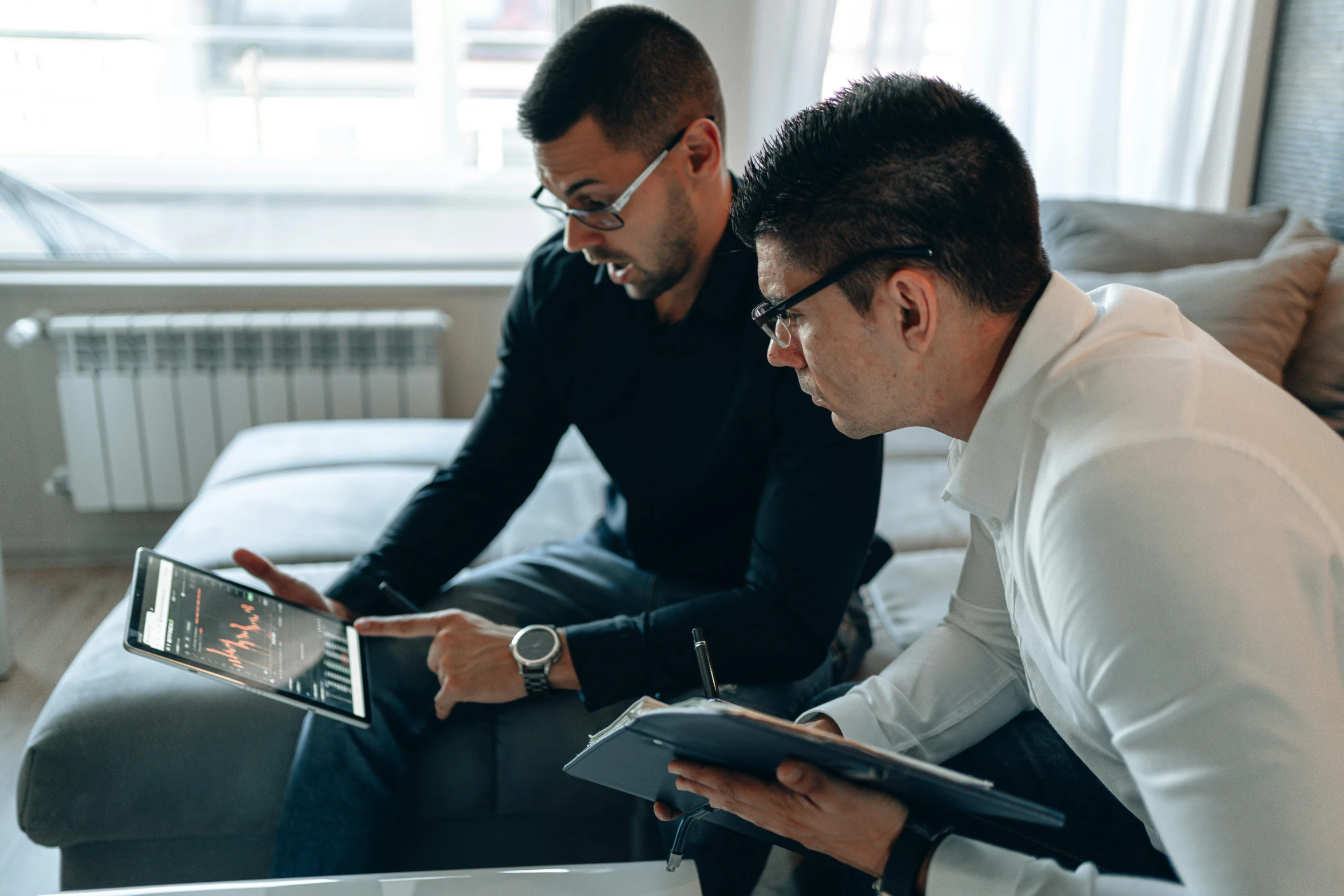 two men sitting on a couch looking at a tablet, pexels contest winner, backrooms office space, doctors office, charts, low quality photo