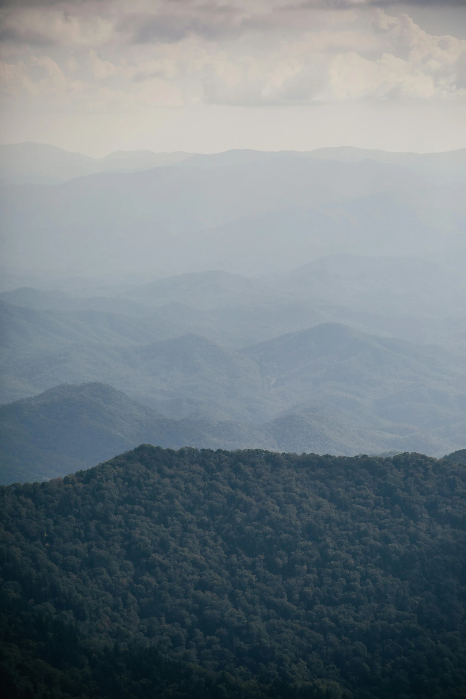 a view of the mountains from the top of a mountain, inspired by Andreas Gursky, sumatraism, very hazy, laos, blue hues, today\'s featured photograph 4k