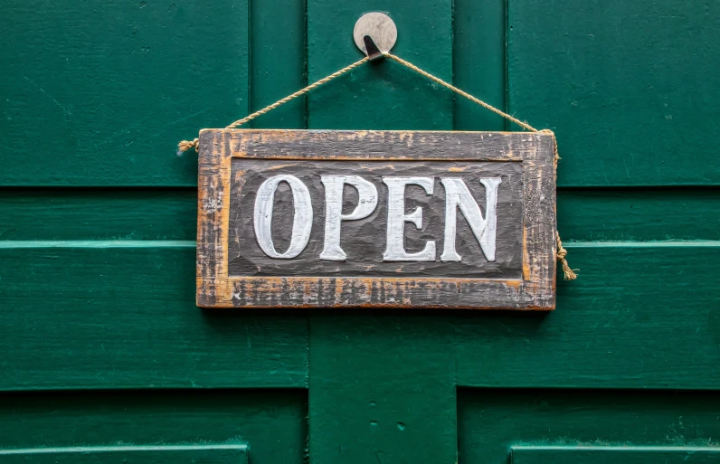 an open sign hanging on a green door, a picture, pexels, happening, square, open vault, 1 6 9 5, brown