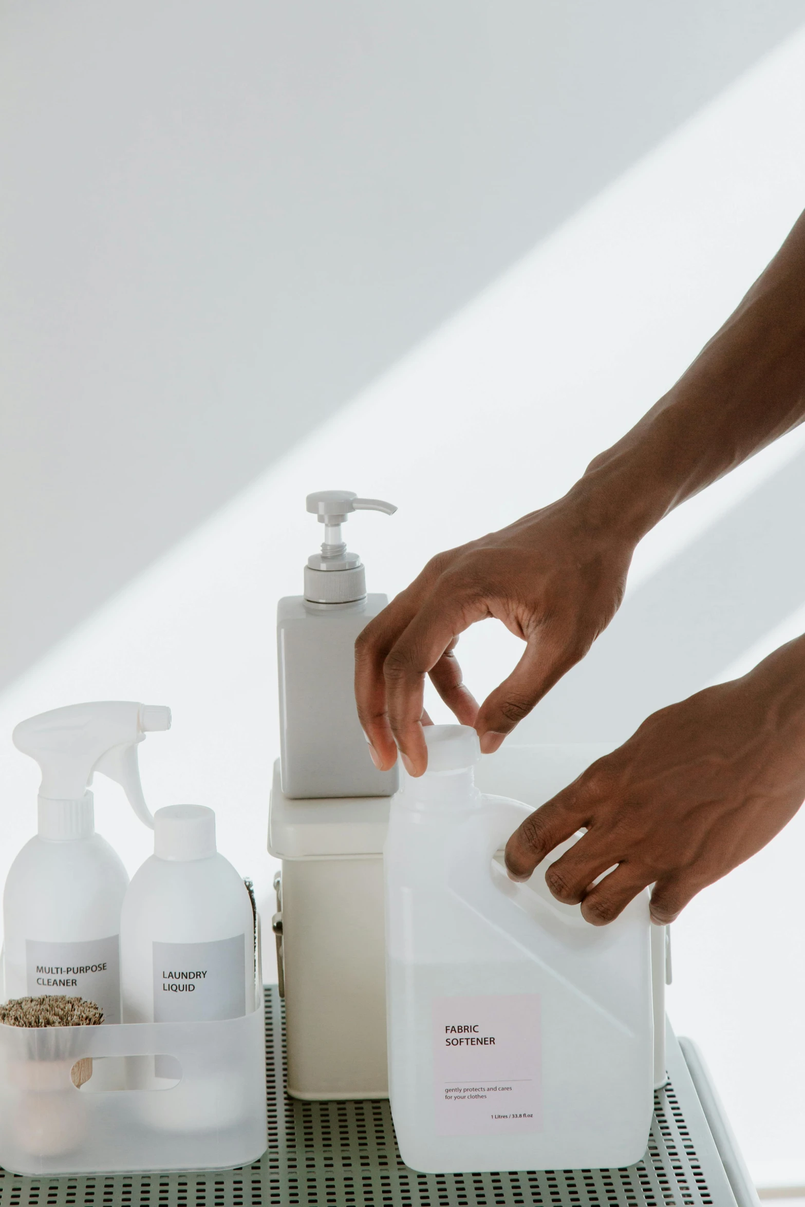 a person using a hand sanitizer on a table, unsplash, plasticien, set against a white background, labels, sustainable materials, 4l