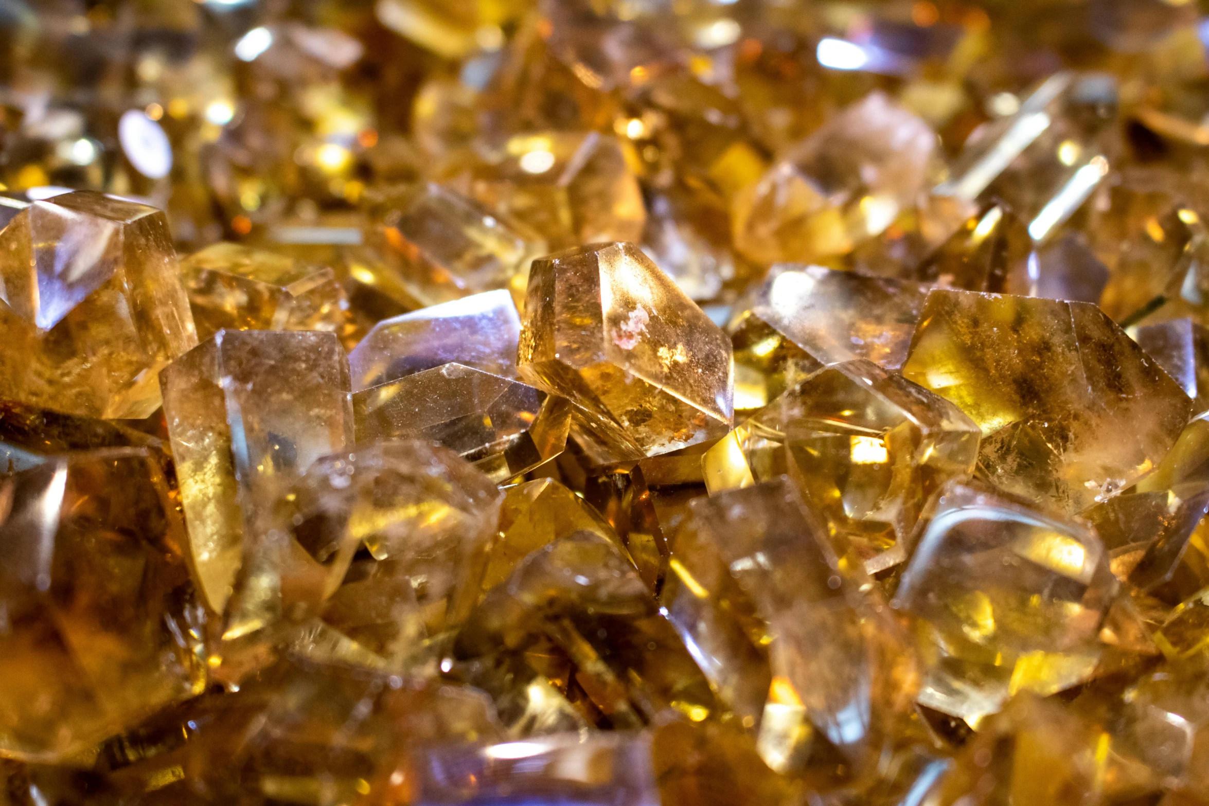 a pile of yellow crystals sitting on top of a table, by Brian Thomas, pexels, brown and gold, glass texture, cnn, 1 0 / 1 0