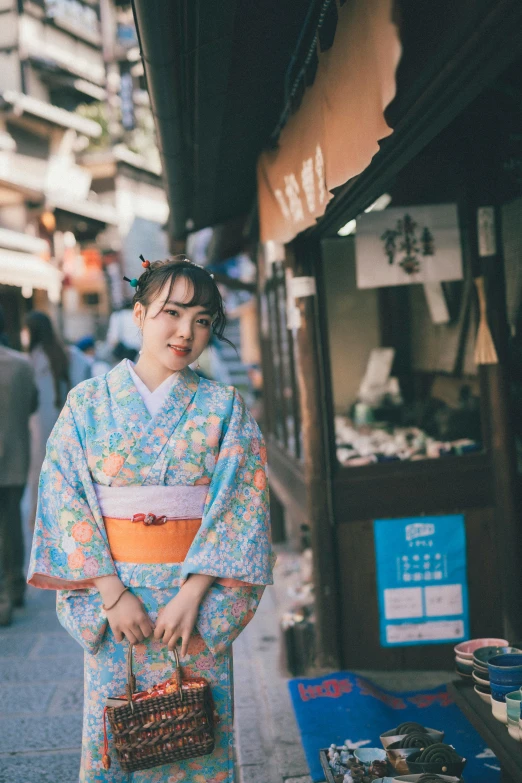 a woman in a kimono walking down a street, inspired by Kaii Higashiyama, unsplash, posing for a picture, 🚿🗝📝, wearing japanese school uniform, ✨🕌🌙