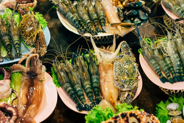 a table topped with lots of different types of food, by Julia Pishtar, trending on unsplash, lion fish, shiny scales, vietnam, thumbnail