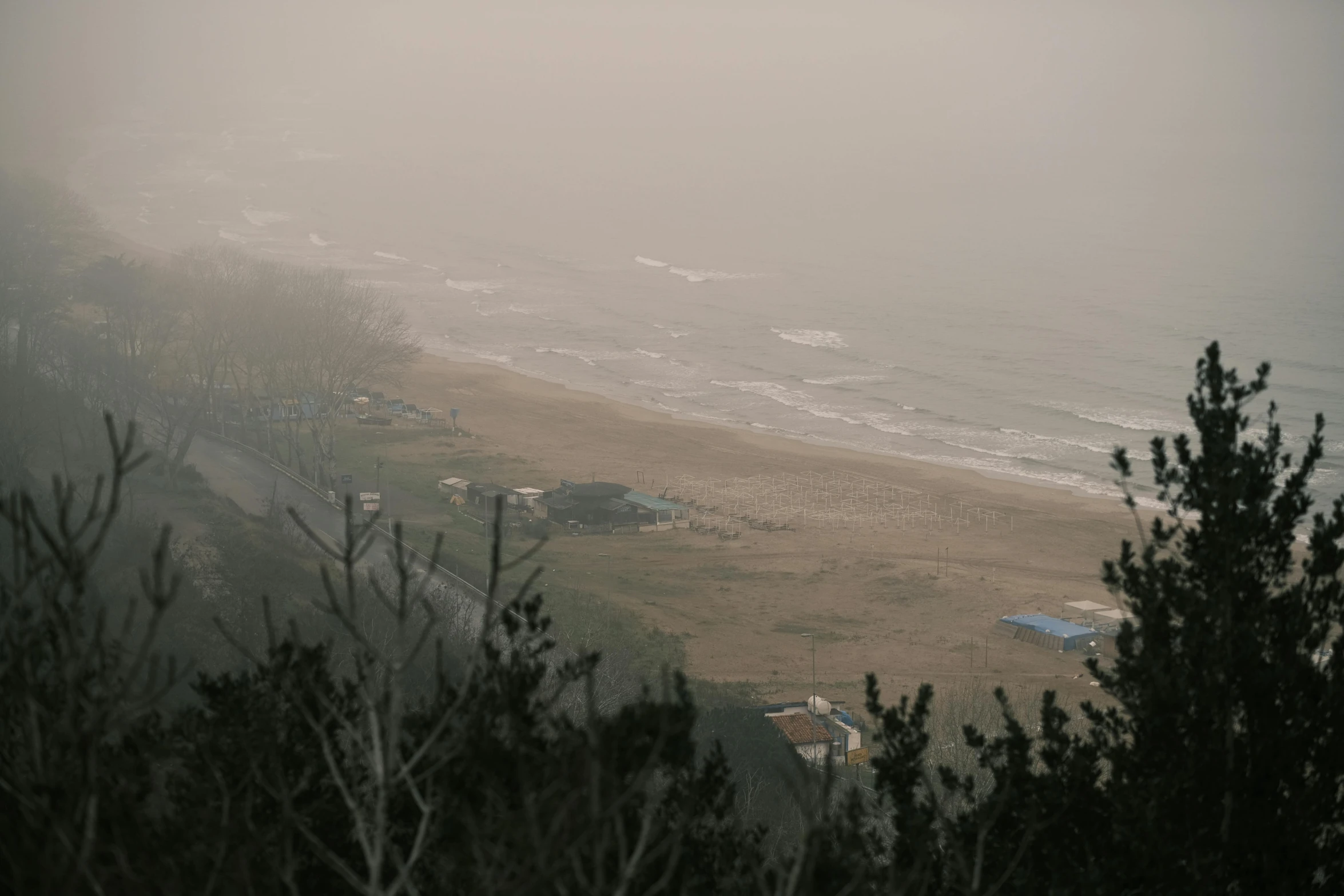 a view of a beach on a foggy day, a picture, unsplash contest winner, mingei, wide high angle view, very hazy, medium height, concert