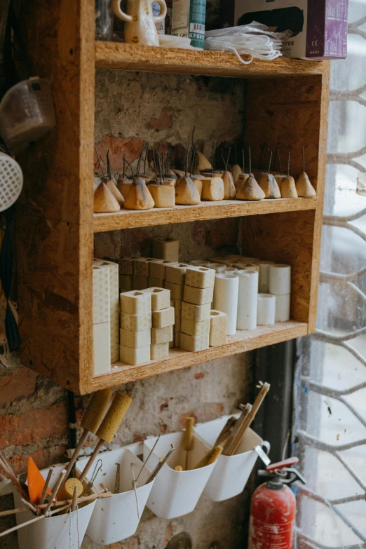 a wooden shelf filled with lots of craft supplies, trending on unsplash, arts and crafts movement, white powder bricks, woodfired, thumbnail, sconces