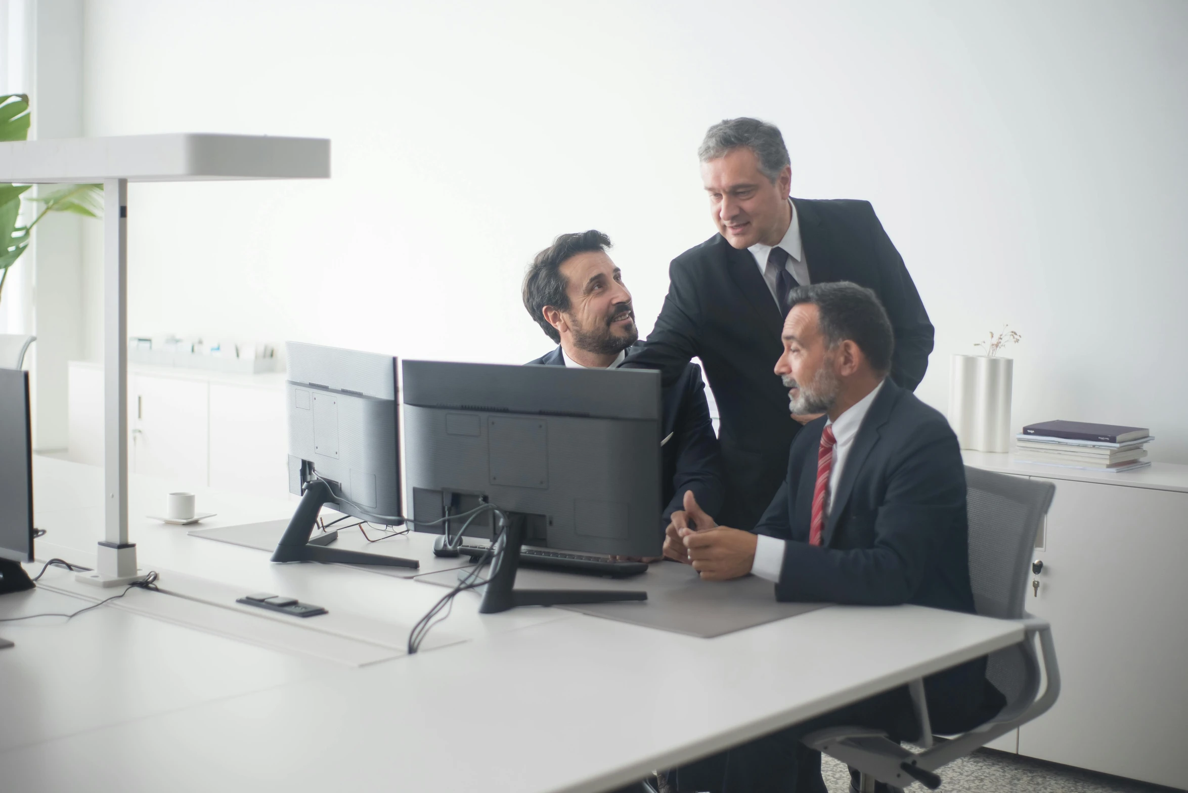 three men in suits are looking at a computer screen, pexels contest winner, renaissance, te pae, in meeting together, grey, half turned around