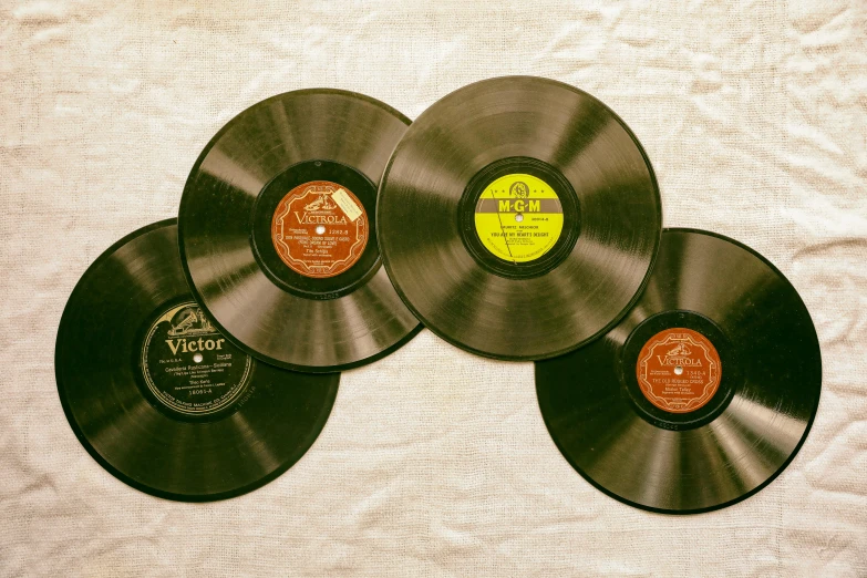 a pile of vinyl records sitting on top of a table, an album cover, by Winona Nelson, pexels, 1930s photograph, flat lay, 4l, deco