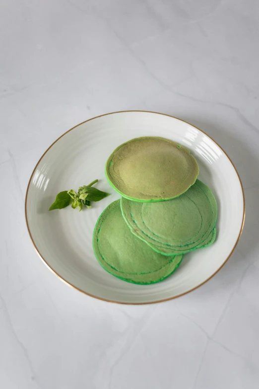 a close up of a plate of food on a table, a pastel, inspired by Art Green, art nouveau, living food adorable pancake, soft rim light, green facemask, smoked layered