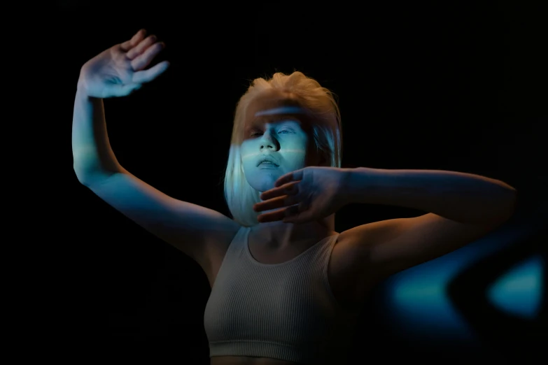 a woman with her hands in the air, a hologram, inspired by Elsa Bleda, unsplash, holography, die antwoord ( yolandi visser ), nebulae. volumetric lighting, avatar image, porcelain holly herndon statue